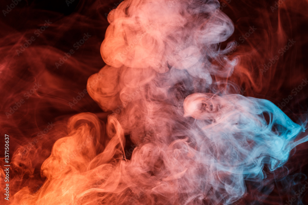 Abstract smoke Weipa. Personal vaporizers fragrant steam. Concept of alternative non-nicotine smoking. Turquoise orange smoke on a black background. E-cigarette. Evaporator. Taking Close-up. Vaping. Abstract smoke Weipa. Personal vaporizers fragrant steam. Concept of alternative non-nicotine smoking. Turquoise orange smoke on a black background. E-cigarette. Evaporator. Taking Close-up. Vaping.