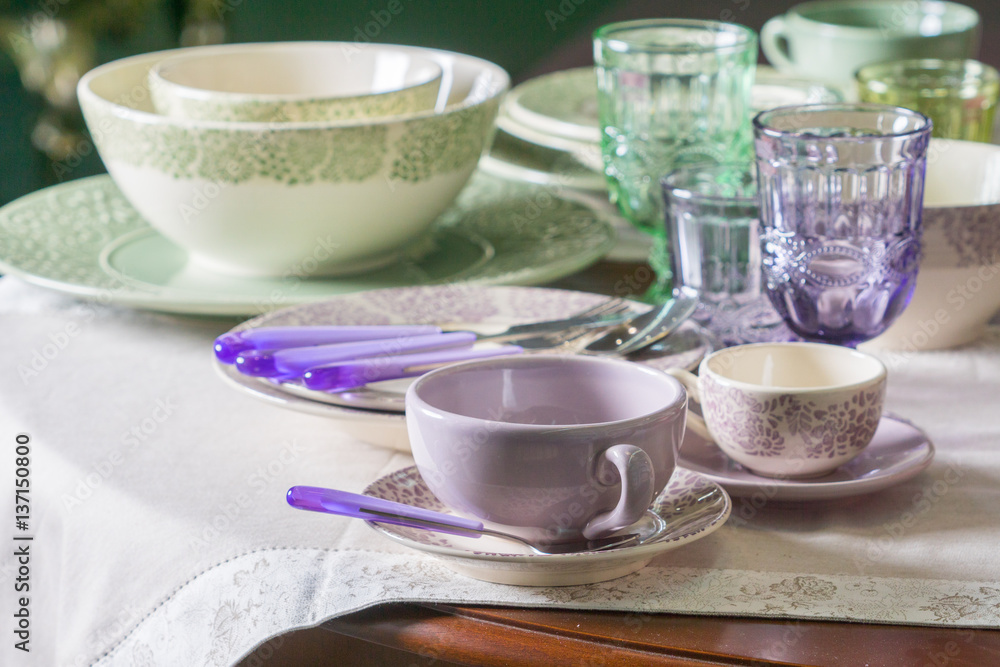 green and purple country styled plates, cup and wine glasses green and purple country styled plates, cup and wine glasses