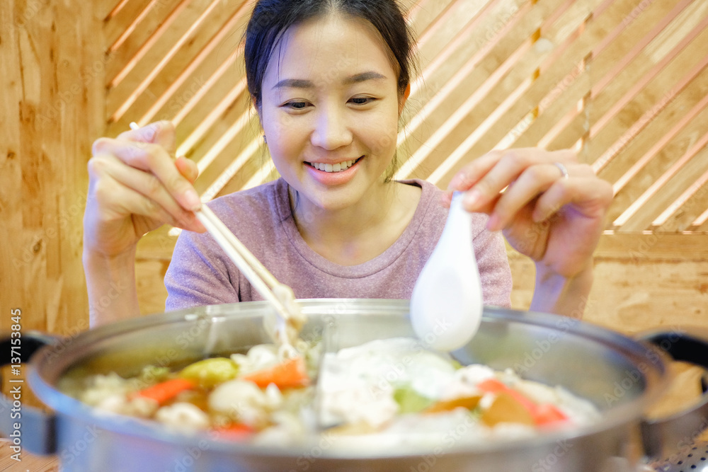 Young woman enjoy eating Shabu-Shabu japanese hot pot Young woman enjoy eating Shabu-Shabu japanese hot pot