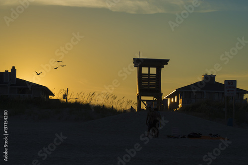 Silohuette of cabin of lifeguards on a yellow sky background