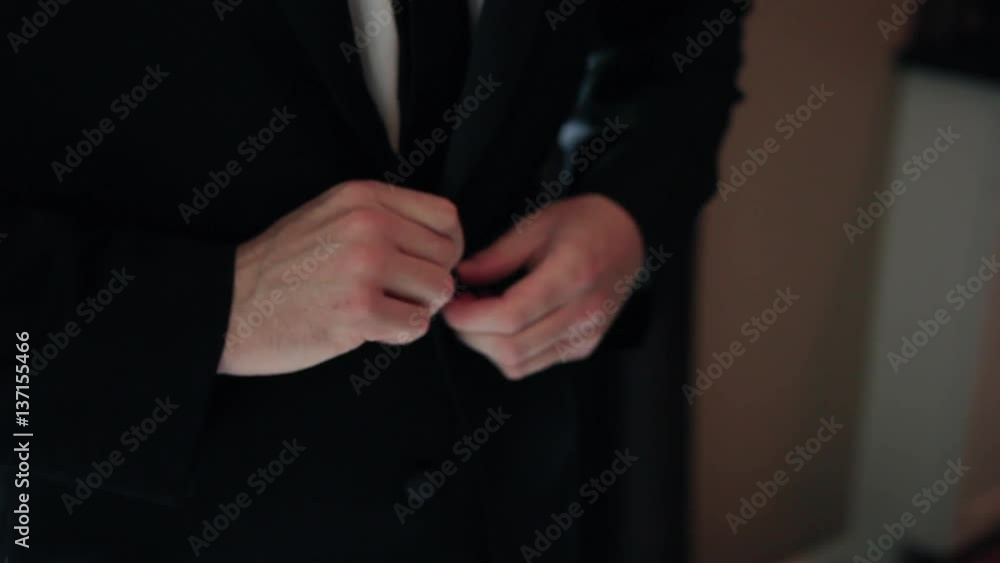 Buttoning up a suit jacket Buttoning up a suit jacket