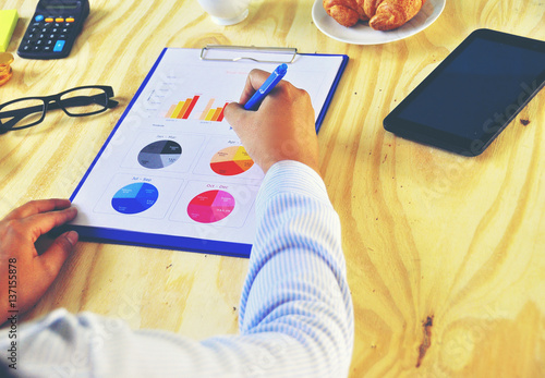 Wallpaper Mural Top view of A young Asian woman's hands that writing on notebook with Smartphone wooden table background,business stuff Torontodigital.ca