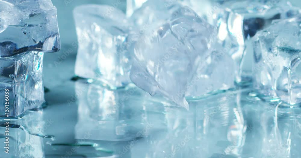Macro shot of pure water ice cubes that melt in slow motion on white background. Concept: pure mountain spring water, ice, cocktails, fresh and frozen products. Macro shot of pure water ice cubes that melt in slow motion on white background. Concept: pure mountain spring water, ice, cocktails, fresh and frozen products.
