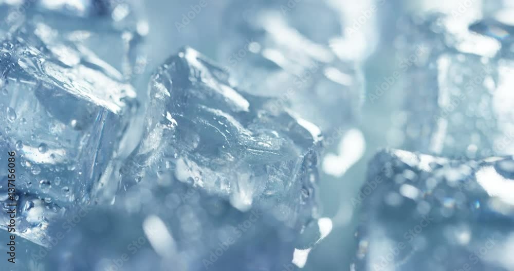 Macro shot of pure water ice cubes that melt in slow motion on white background. Concept: pure mountain spring water, ice, cocktails, fresh and frozen products. Macro shot of pure water ice cubes that melt in slow motion on white background. Concept: pure mountain spring water, ice, cocktails, fresh and frozen products.