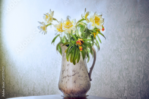 Vase of daffodils and wallflowers morning light photo