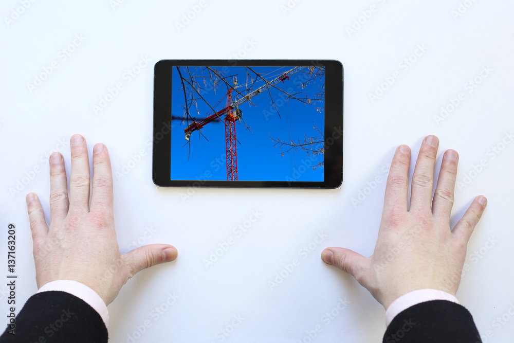 tablet in his hands. The construction manager. tablet in his hands. The construction manager.