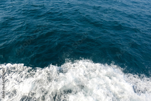 Deep blue sea and white water splash