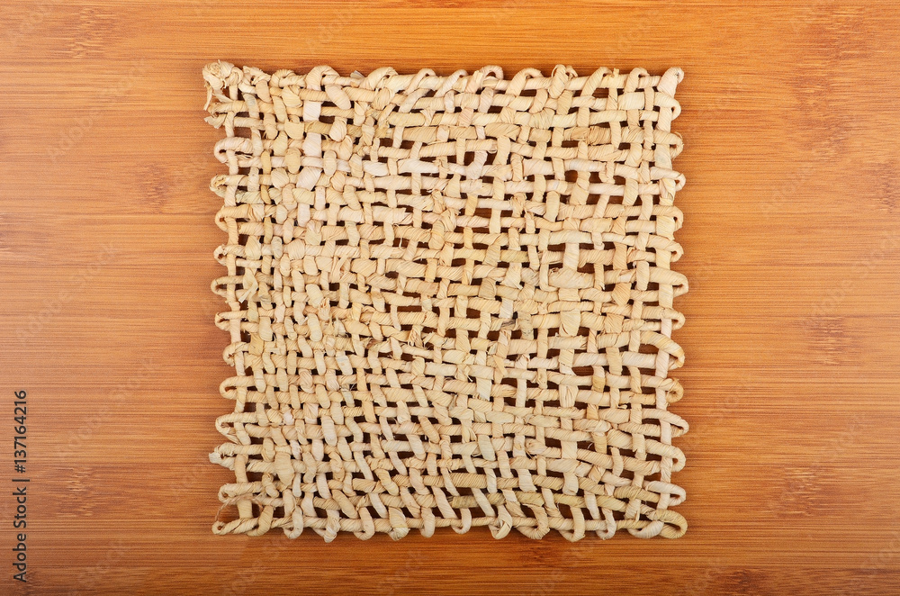 Wickered napkin on wooden background Wickered napkin on wooden background