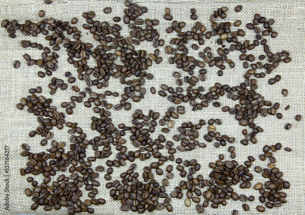 Coffee beans on a background of canvas Coffee beans on a background of canvas