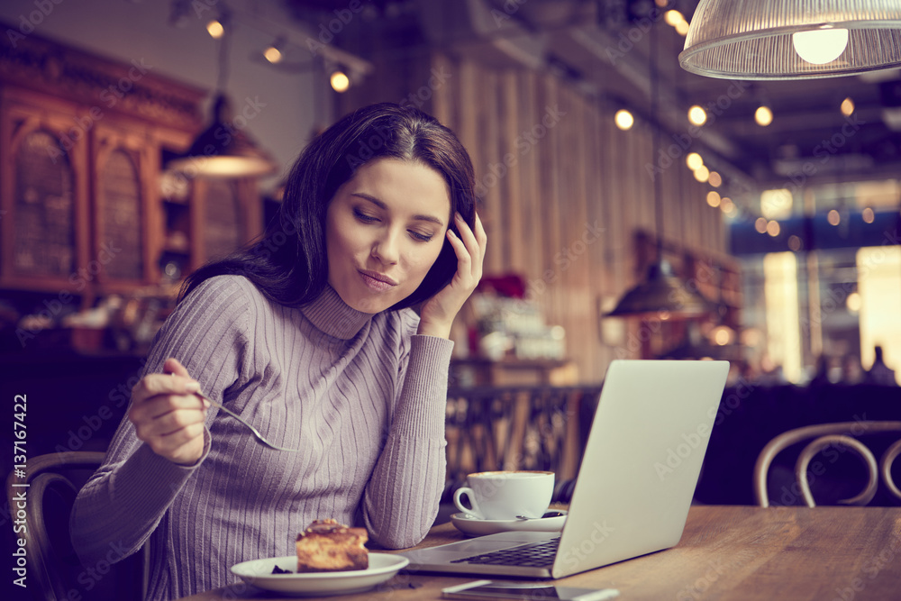 Beautiful brunette using laptop in cafe. Blogger work concept Beautiful brunette using laptop in cafe. Blogger work concept