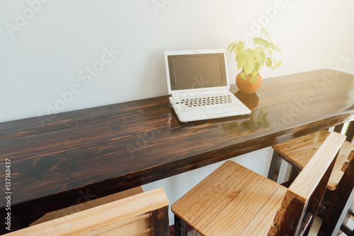 Laptop sitting on empty table