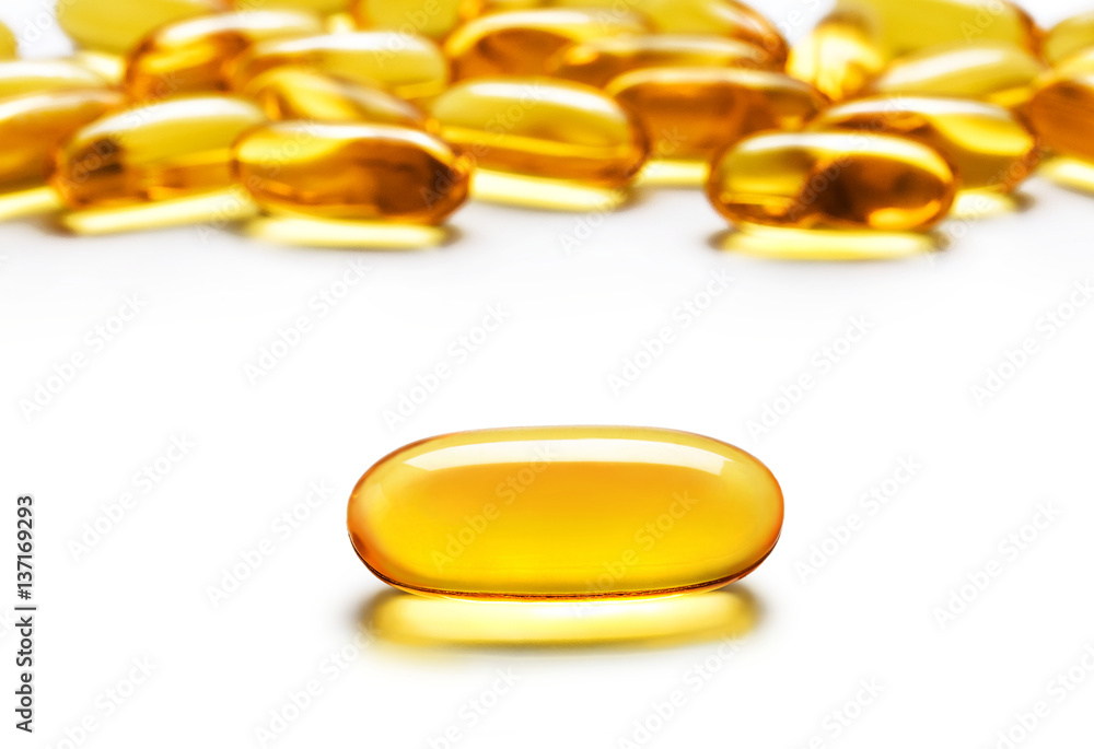 Close up one capsule Omega 3 and many other of capsules isolated on white background. High resolution product. Health care concept Close up one capsule Omega 3 and many other of capsules isolated on white background. High resolution product. Health care concept