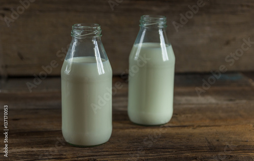 Milk in a bottle on a wooden background