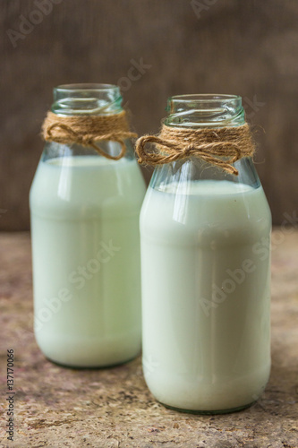 milk in a bottle on a wooden background