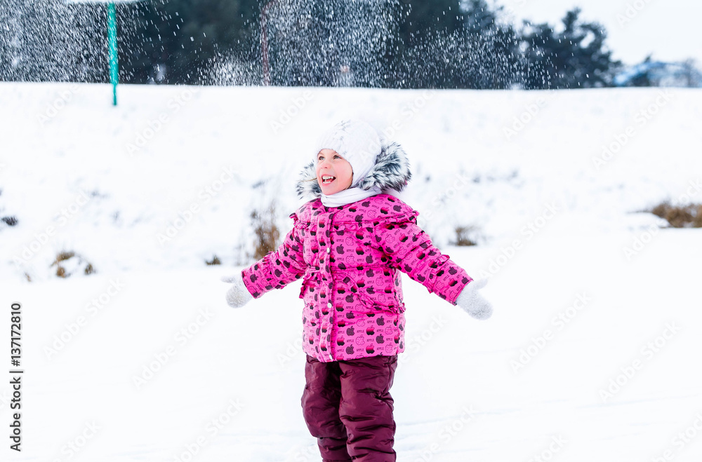 Little girl throwing snow in the winter in nature Little girl throwing snow in the winter in nature