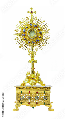 Fotografi Gold monstrance on the pedestal engraving 4 saints on white background
