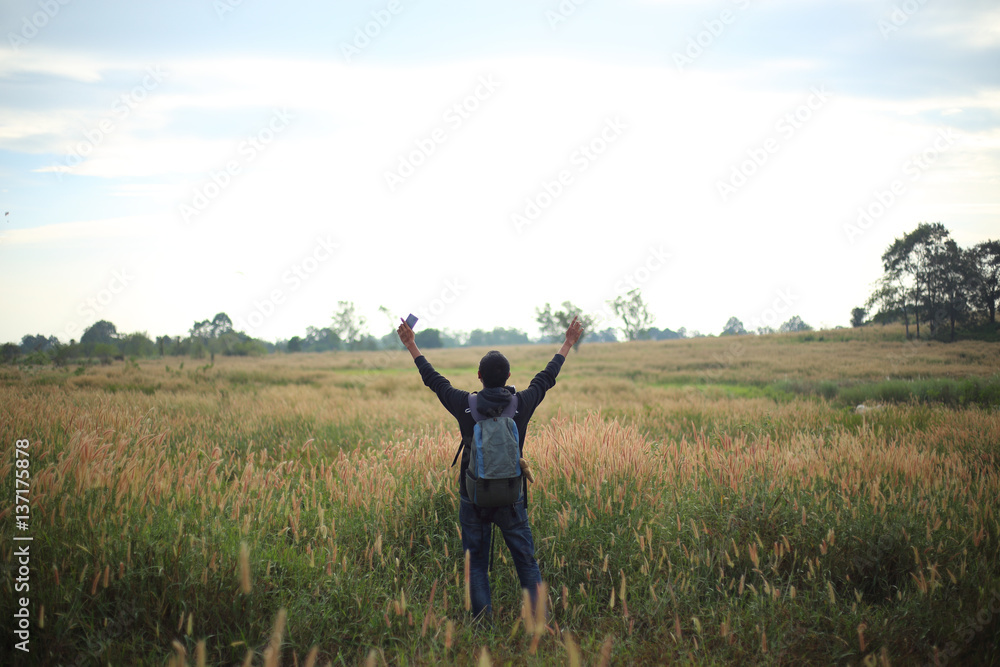 Man standing at Pennisetum pedicellarum weed plant flower in Wide field Man standing at Pennisetum pedicellarum weed plant flower in Wide field