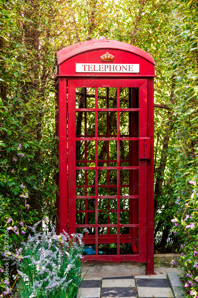 Fototapeta premium Red Phone Booth in the garden