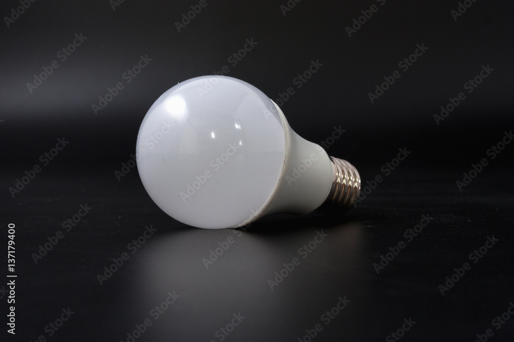 economical light bulb on a black background. economical light bulb on a black background.