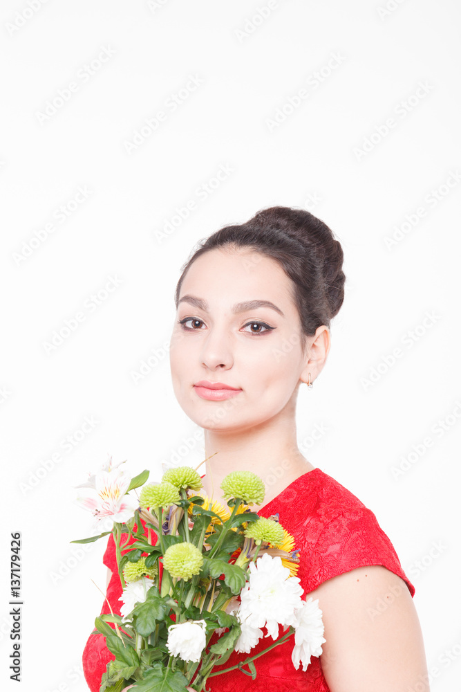 Beautiful well-groomed woman with a bouquet of flowers in their hands Beautiful well-groomed woman with a bouquet of flowers in their hands