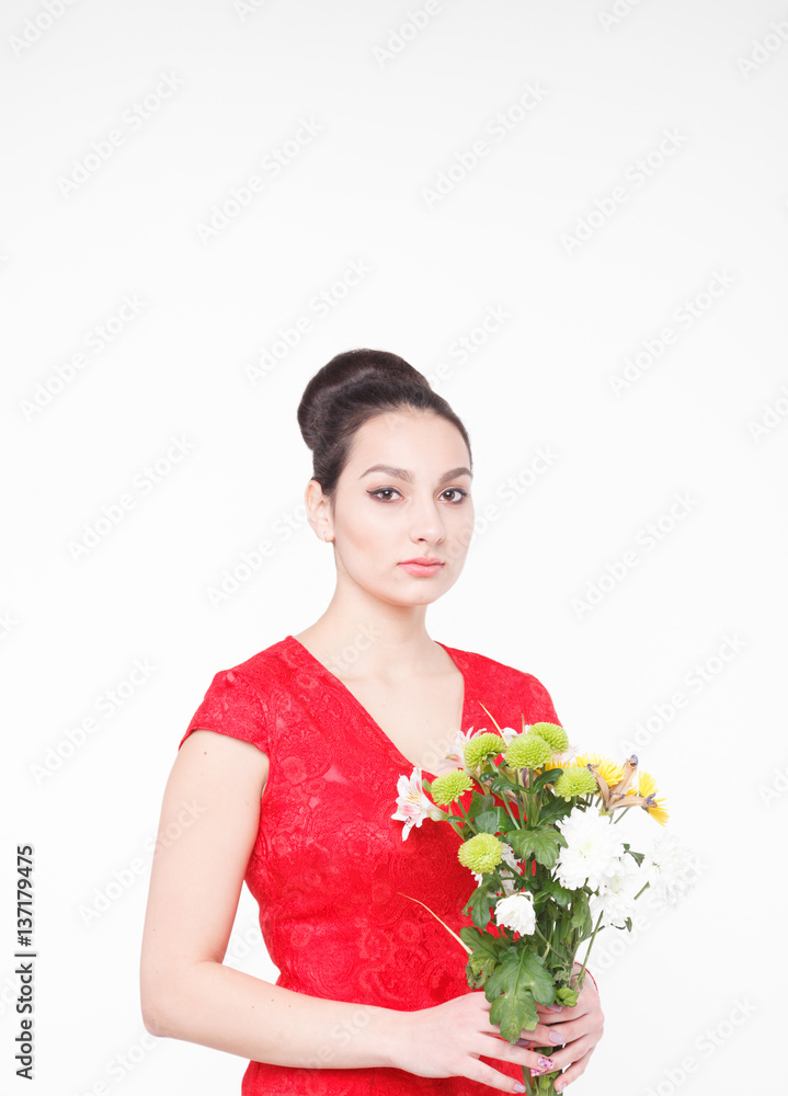 Beautiful well-groomed woman with a bouquet of flowers in their hands Beautiful well-groomed woman with a bouquet of flowers in their hands