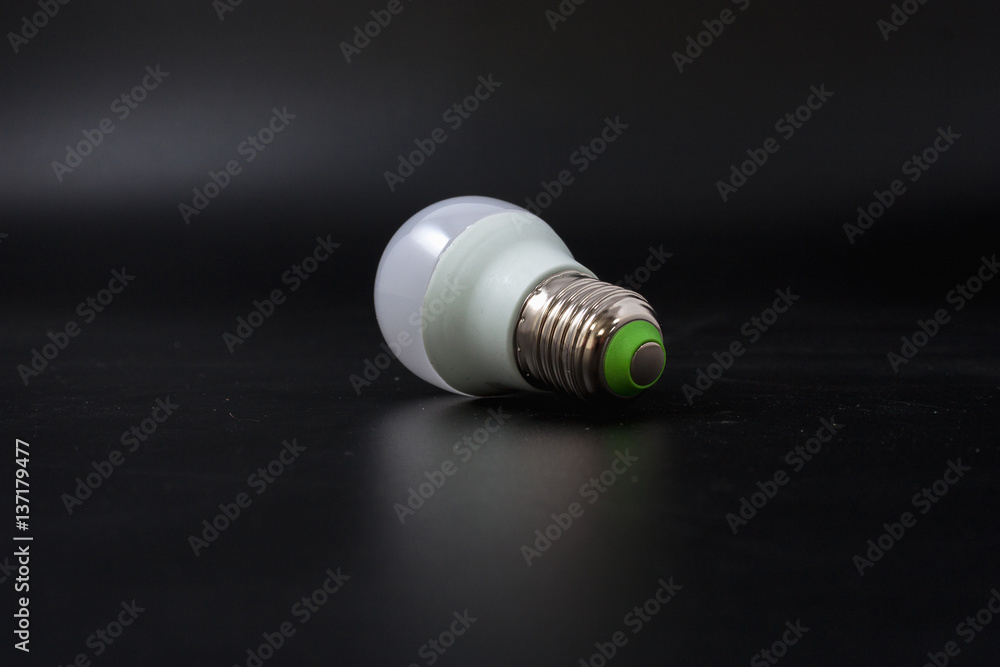 economical light bulb on a black background. economical light bulb on a black background.
