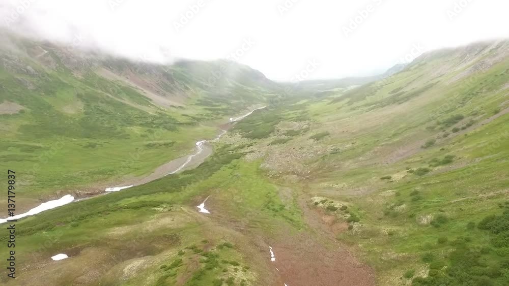 Aerial View Kamchatka. Flying over the stones and snow. flight. fog Aerial View Kamchatka. Flying over the stones and snow. flight. fog