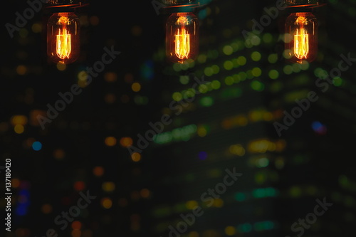 three lamp bulb on city bokeh light at dark night