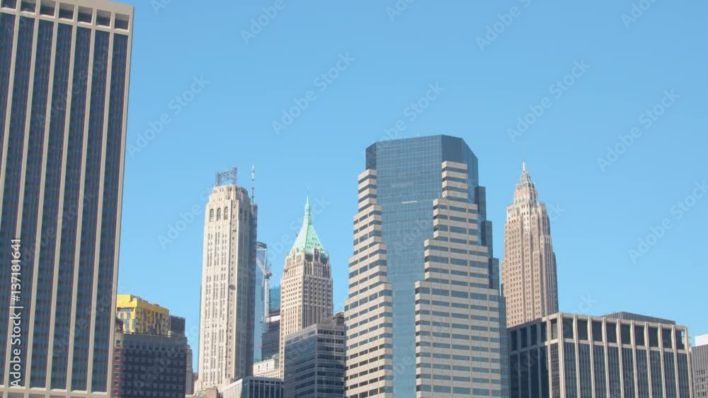 CLOSE UP: Contemporary glassy skyscrapers and office buildings against blue sky CLOSE UP: Contemporary glassy skyscrapers and office buildings against blue sky