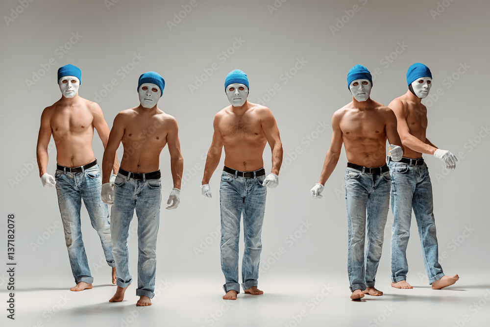 The group of caucasian men in white masks and hats, jeans - obrazy, fototapety, plakaty 