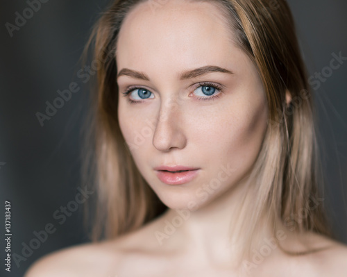 Portrait of a beautiful young woman with blue eyes.