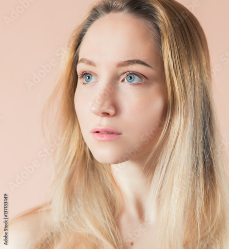 Beautiful young woman with blue eyes. Color toned image.