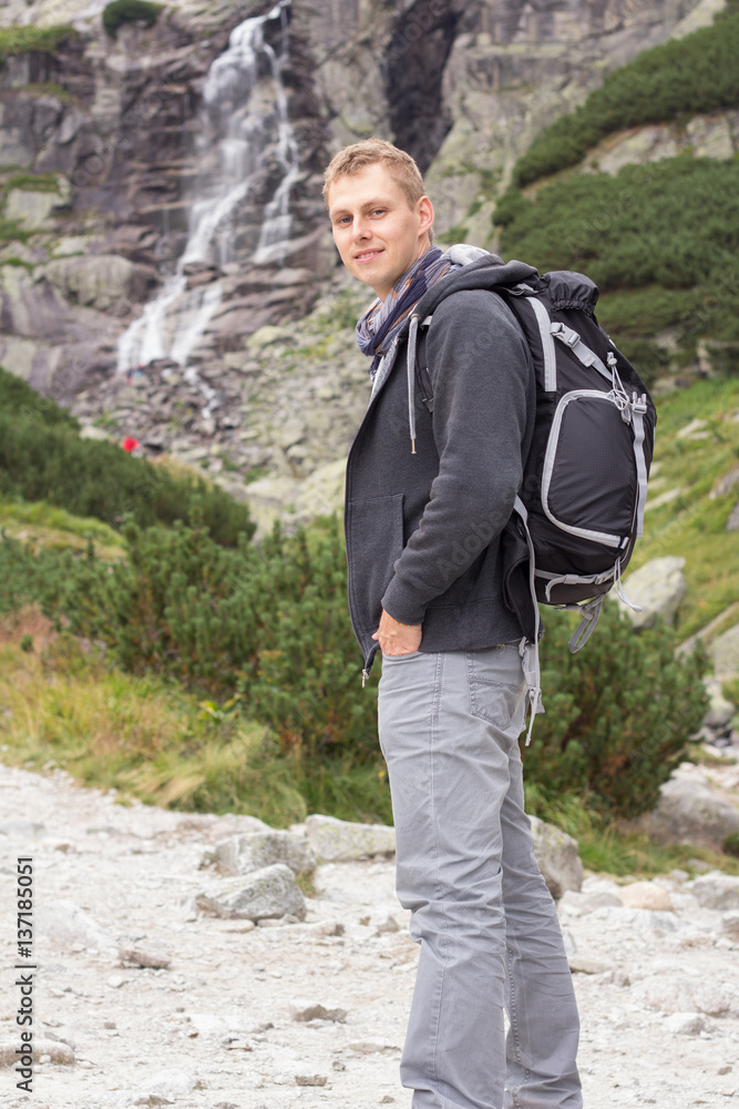 tourist man in nature with waterfall tourist man in nature with waterfall