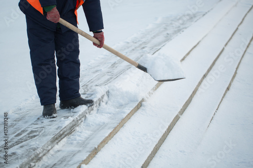 Workers sweep snow from road in winter, Cleaning road from snow storm.