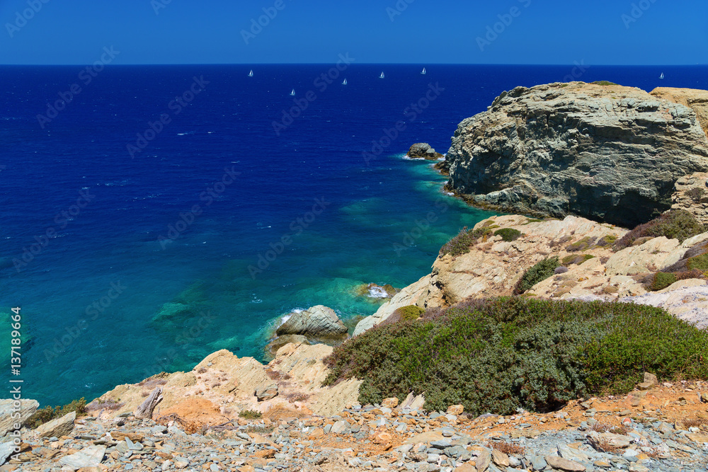 Top view of the steep rocky shore in a small town called Agia Pelagia, Crete. Beautiful mountainous sea shore. Inaccessible cliffs on the coast. Top view of the steep rocky shore in a small town called Agia Pelagia, Crete. Beautiful mountainous sea shore. Inaccessible cliffs on the coast.