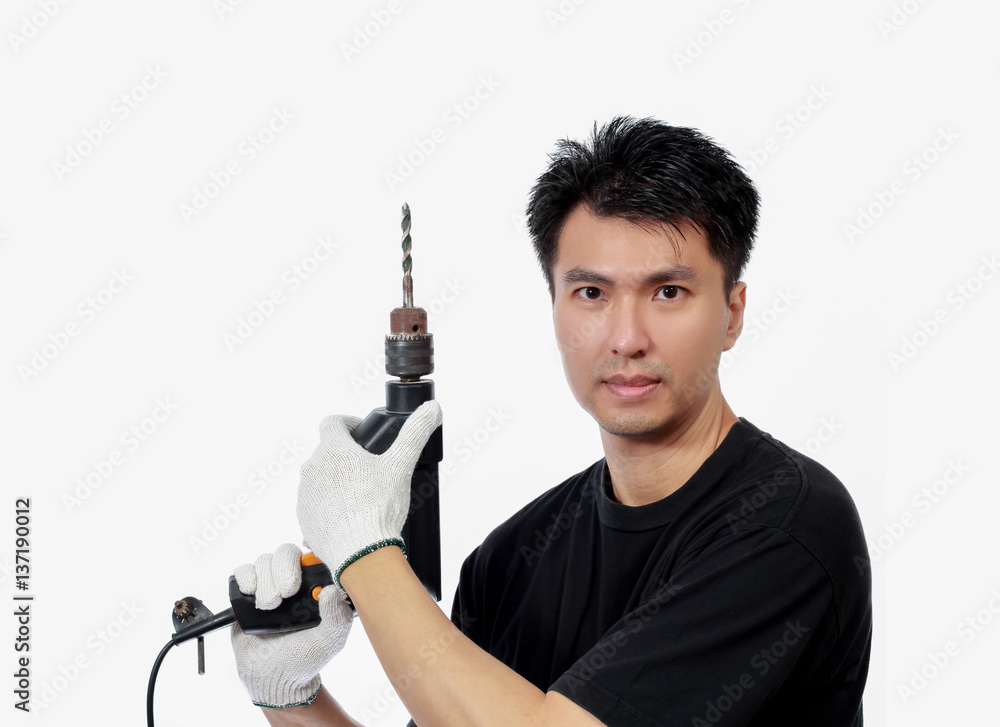 asian handsome craftsman with electric drill, isolated on white. Home Improvement, Renovation Set and DIY concept asian handsome craftsman with electric drill, isolated on white. Home Improvement, Renovation Set and DIY concept