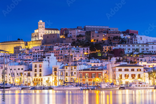 Ibiza Dalt Vila downtown at night with light reflections in the water, Ibiza, Spain. photo