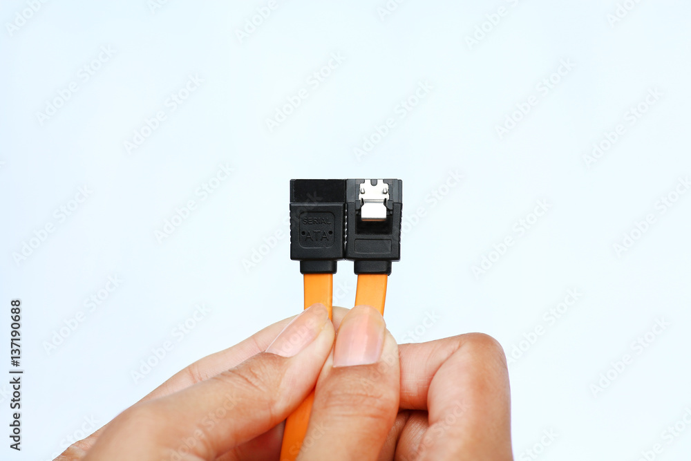 Hands holding sata data cable on white background Hands holding sata data cable on white background