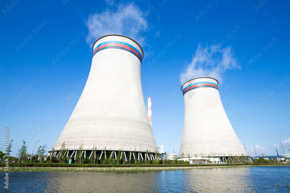 modern power plant near river in blue sky modern power plant near river in blue sky