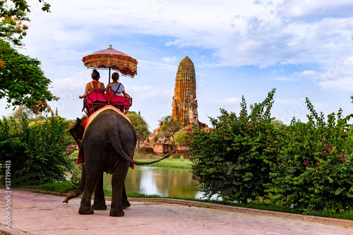 Tourists on an elephant ride tour of the ancient city Ayutaya ,thailand © tonjung