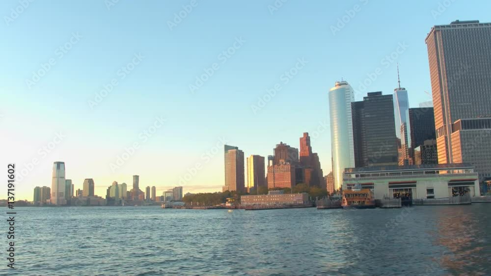 Iconic Lower Manhattan skyline at golden sunset and New Jersey in the distance Iconic Lower Manhattan skyline at golden sunset and New Jersey in the distance