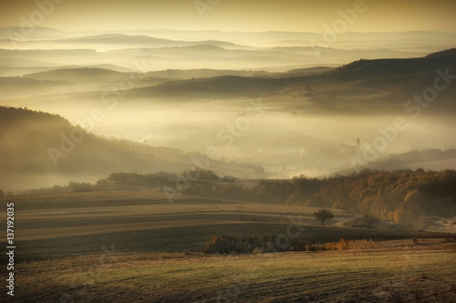 Misty morning landscape. Fog and hills in sunrise light  natural scenery