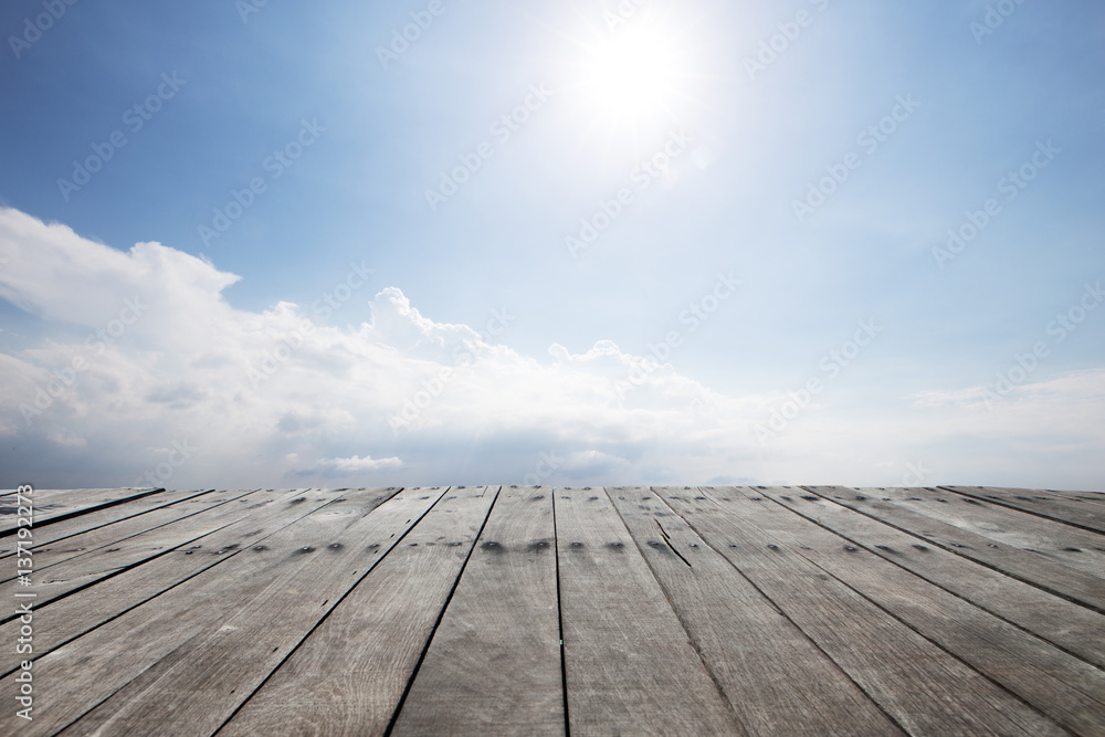 empty wood floor in blue sunny sky