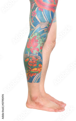 Full Oriental japanese style tattoo on leg of caucasian man isolated on white background.