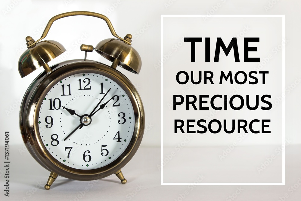 Text Time our most precious resource on clock background / time concept Text Time our most precious resource on clock background / time concept