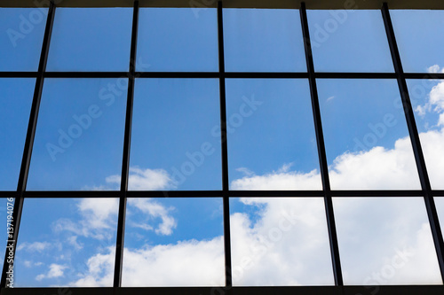 blue sky and white cloud through silhouette window frame