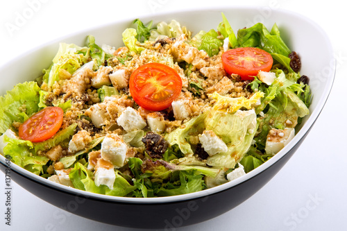 Lettuce salad tomato cheese and nuts