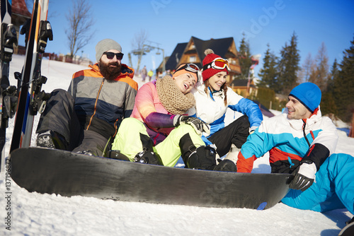 Four of friends with snowboarders on the snow © gpointstudio