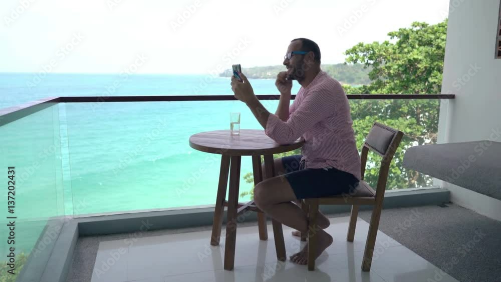 custom made wallpaper toronto digitalHappy, young man chatting on smartphone sitting on terrace