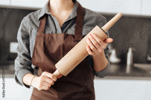 Cropped image of young woman standing in kitchen